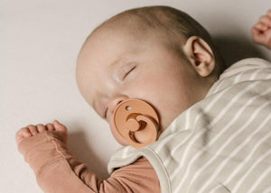 Baby sleeping with pacifier