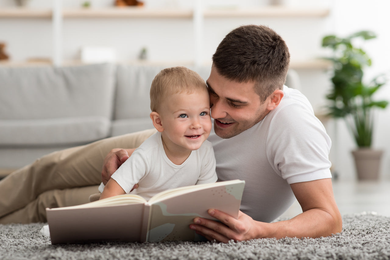 Dad bonding with baby while reading a book